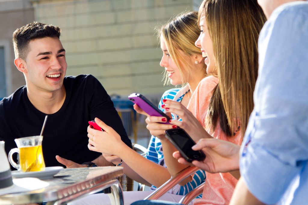 Friends having fun with smartphones